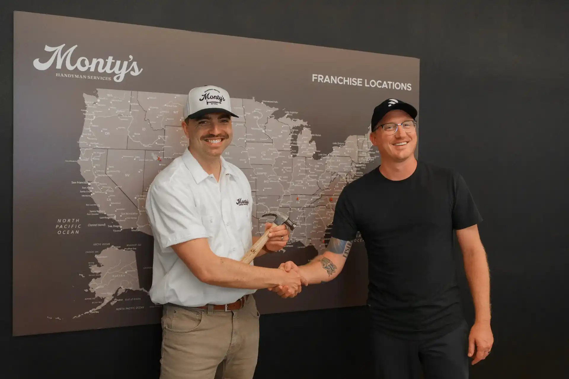 The ResiBrands franchise team standing together in front of branded vans