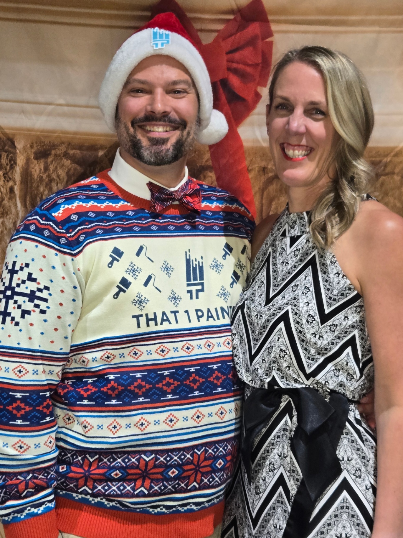 Geoff Petis and his partner at a holiday event wearing That 1 Painter apparel.
