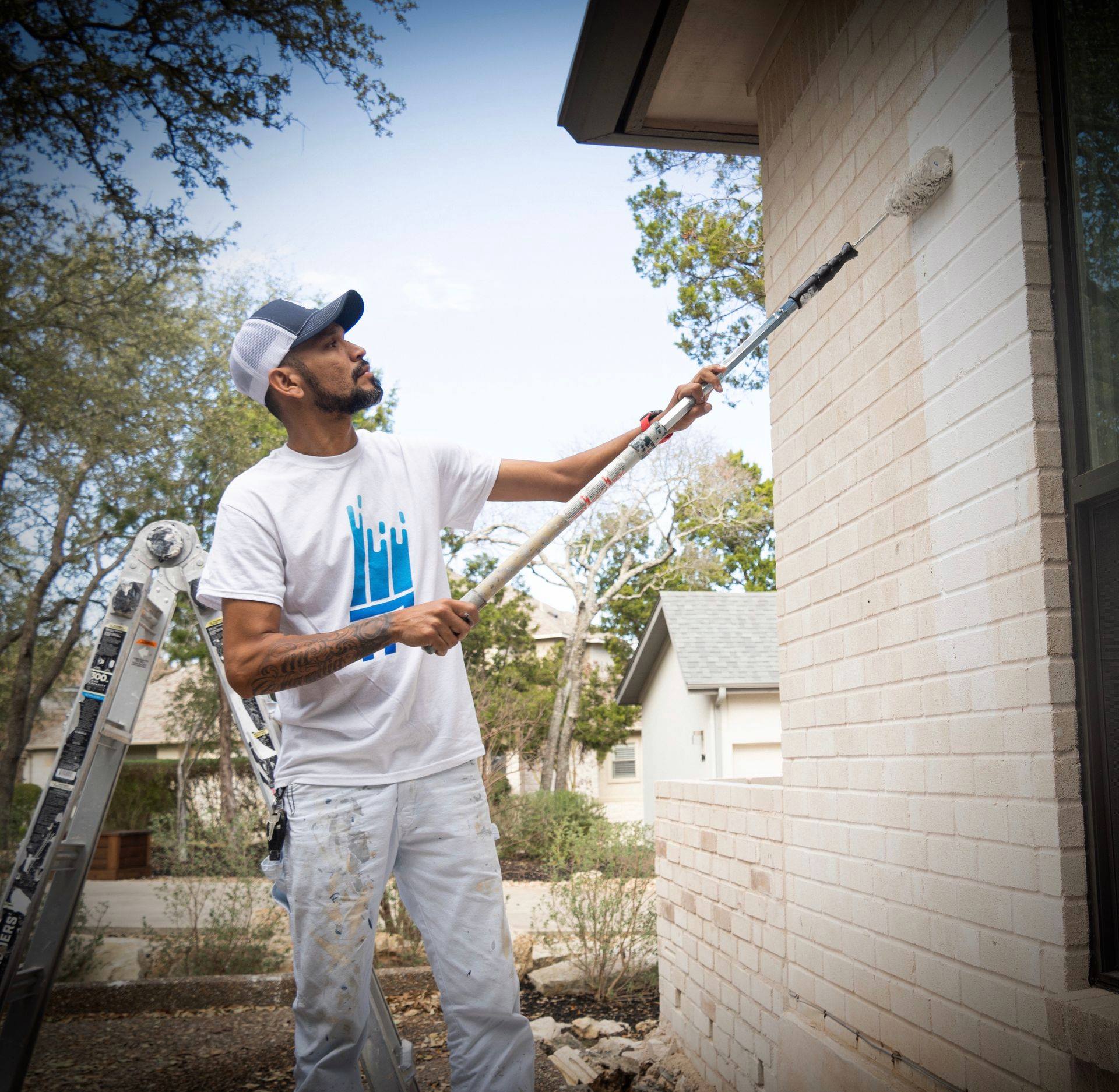 Man painting brick house