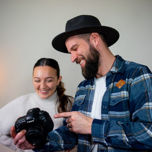 workers looking at image on digital camera